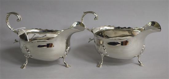 A pair of late Victorian silver sauceboats with flying scroll handles, Nathan & Hayes, Chester, 1900, .5 oz.